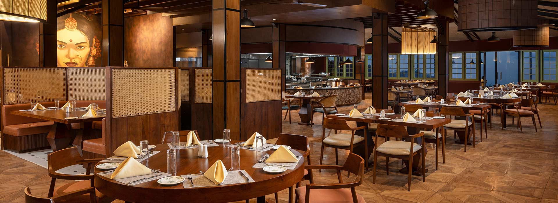 The main dining room, with round tables laid in white and timber panelling