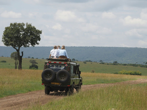 Safari jeep drive through open grasslands during a Sri Lanka wildlife safari in Minneriya