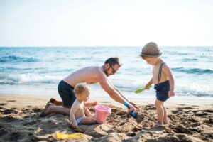 Family enjoying the sand and sea at Beruwala Beach, Sri Lanka
