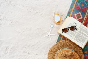Relaxing beach setting with a book and sunglasses on the golden sand of Beruwala Beach, Sri Lanka