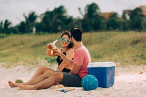 Couple relaxing on Bentota beach enjoying drinks during a laid-back coastal holiday in Sri Lanka