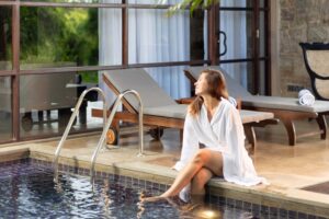 Woman relaxing by pool after Panchakarma treatment at Ayurveda wellness retreat in Sri Lanka