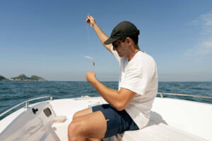 An angler preparing fishing line on a boat during fishing in Sri Lanka east coast waters