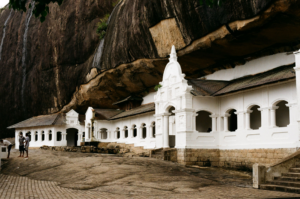 Visitors walking towards the cave temple near Sigiriya