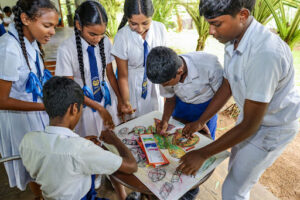 Students creating turtle-themed chalk drawings during the World Turtle Day programme