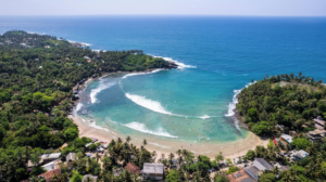 Aerial view of Hiriketiya Beach looking out towards the sea