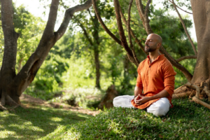 A guest meditating in the gardens of Ayugiri Ayurveda Wellness Resort near Sigiriya