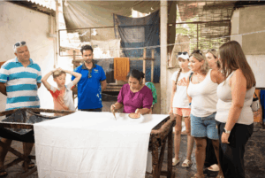 Guests watching a batik artisan at work during a factory visit.