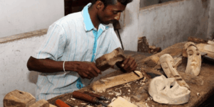 An artisan hand-carving a traditional mask in Ambalangoda, Sri Lanka.