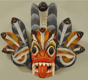 A traditional Raksha demon mask with a serpent crown.