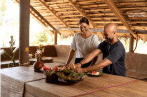 Couple eating fresh fruit as part of their stay at Ayugiri.